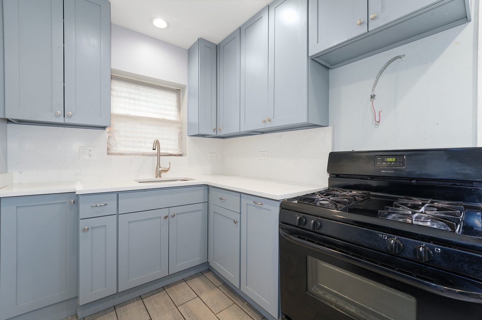 10233 South Calhoun Avenue Chicago, IL 60617 - Photo 14 of 22 a kitchen with cabinets appliances and a window