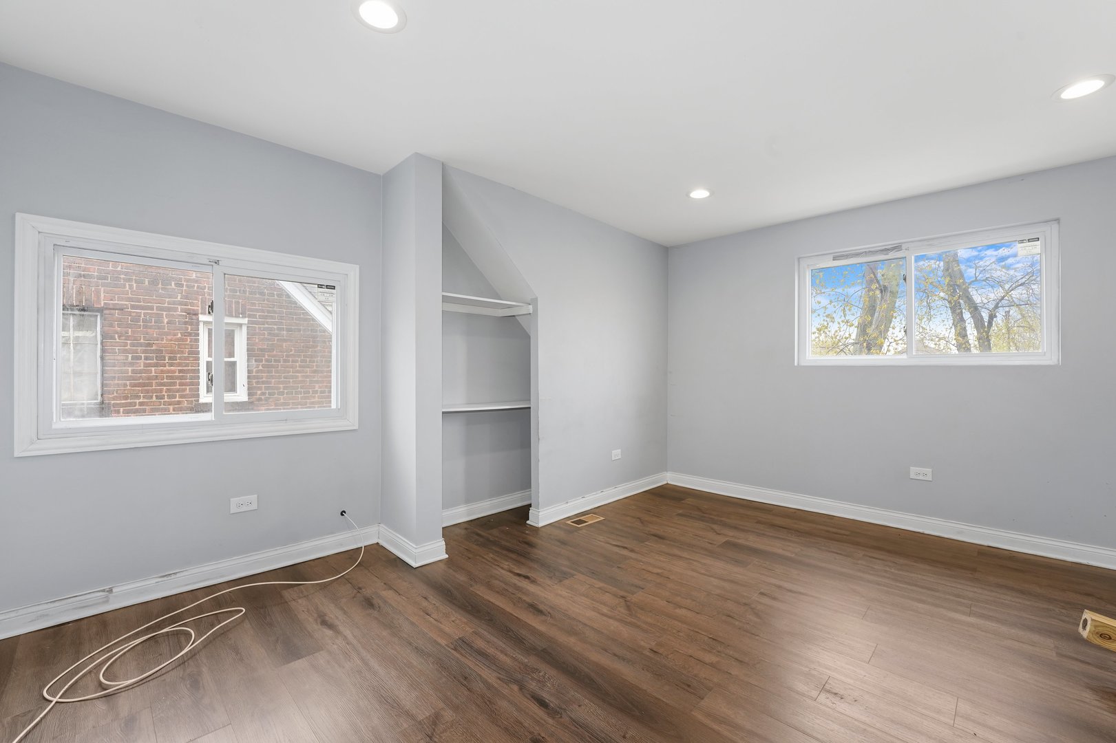 10233 South Calhoun Avenue Chicago, IL 60617 - Photo 17 of 22 a view of empty room with wooden floor and fan