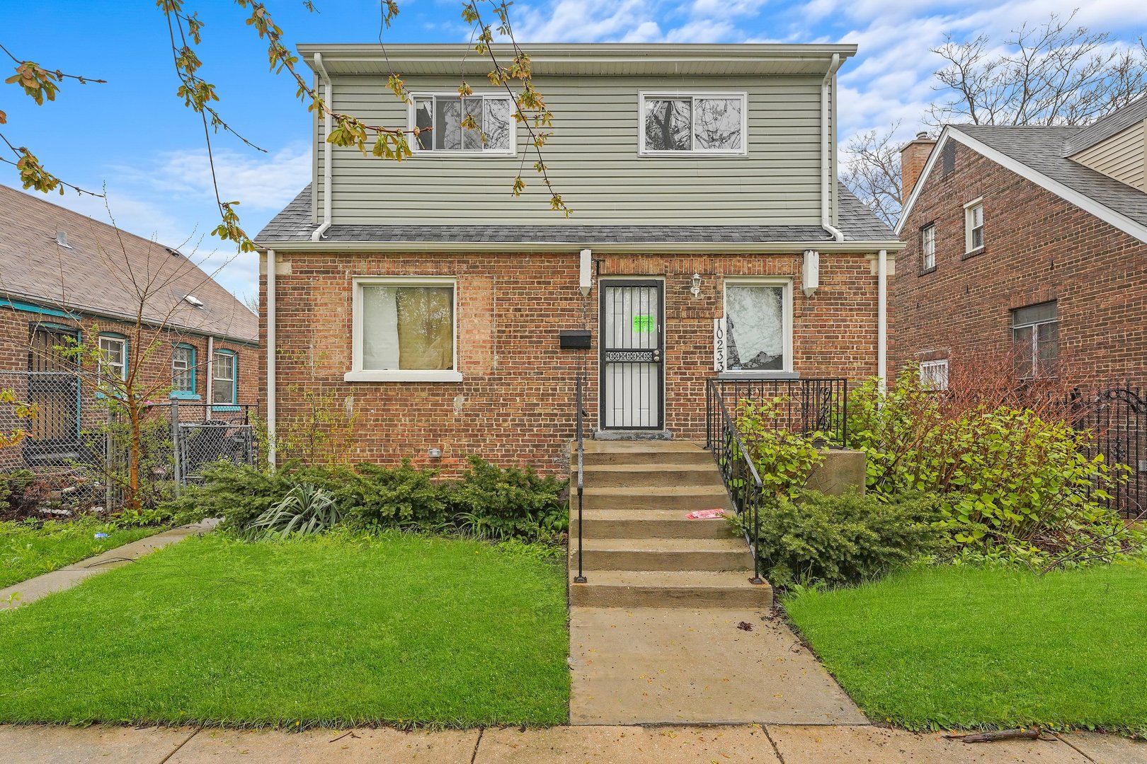 10233 South Calhoun Avenue Chicago, IL 60617 - Photo 2 of 22 a front view of a house with garden