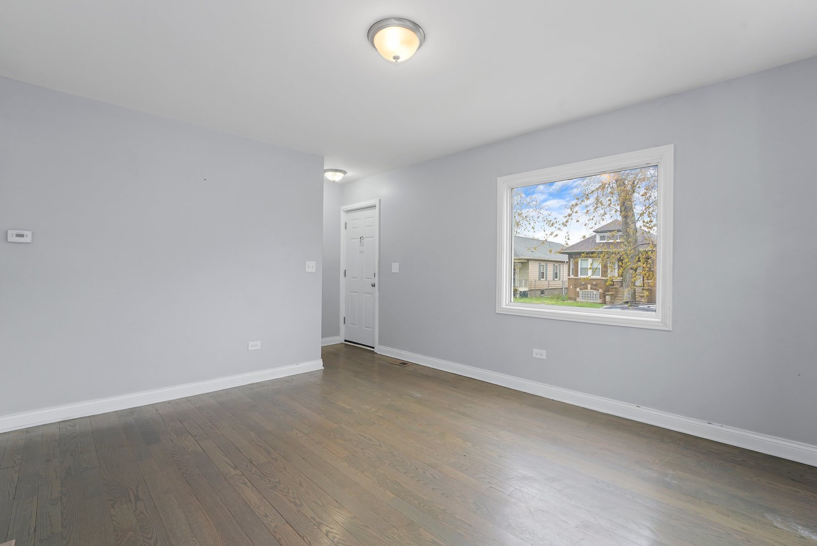 10233 South Calhoun Avenue Chicago, IL 60617 - Photo 4 of 22 an empty room with windows