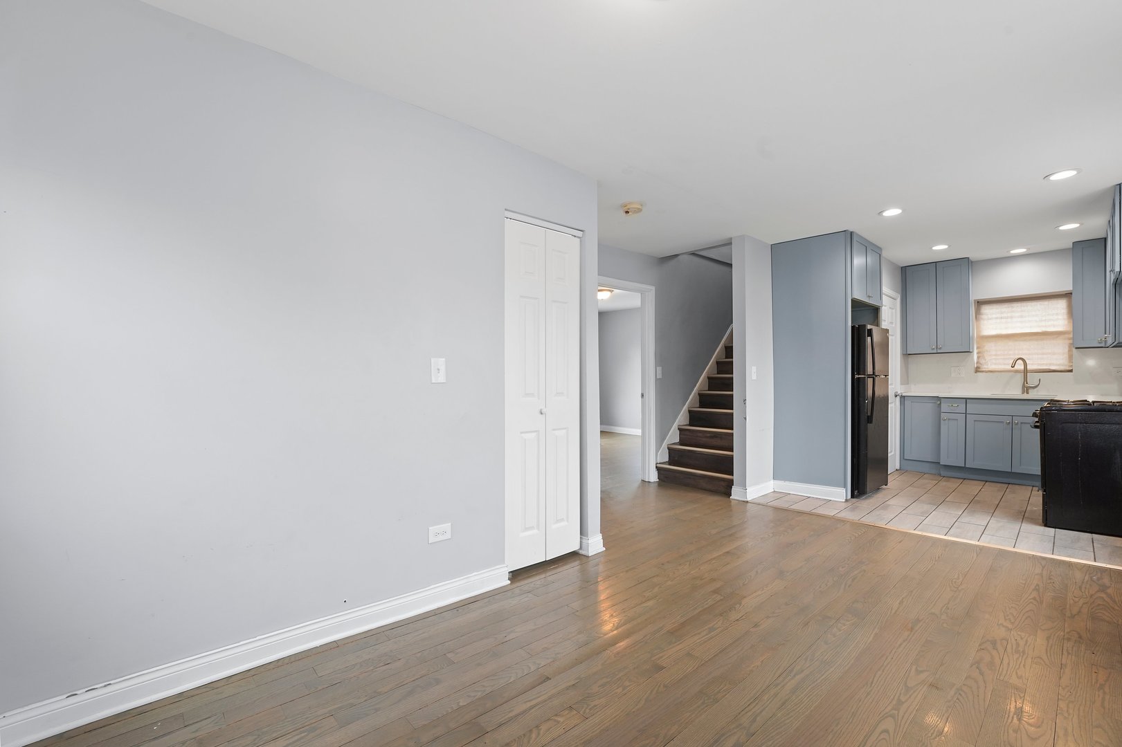 10233 South Calhoun Avenue Chicago, IL 60617 - Photo 10 of 22 a view of a hallway with wooden floor and kitchen