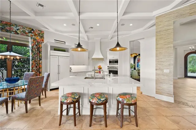 a kitchen with white cabinets and appliances