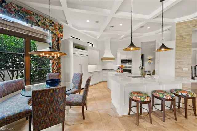 a view of a dining room with furniture wooden floor and a chandelier
