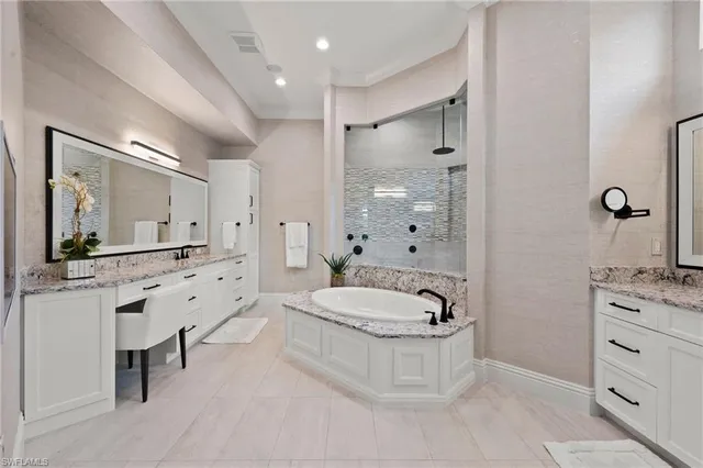a bathroom with a tub sink and mirror