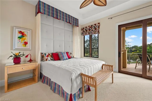 a living room with patio furniture and large windows