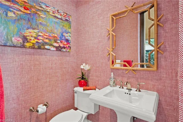 a living room with furniture a flat screen tv and a flat screen tv