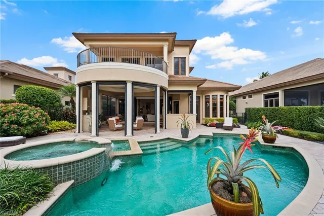 a view of a patio with couches table and chairs potted plants and palm tree