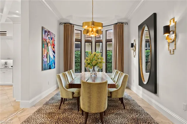 a dining room with furniture a chandelier and window