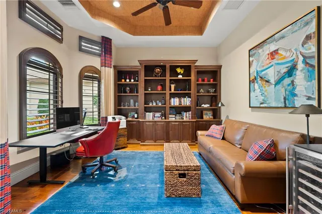 a living room with furniture a rug and a bookshelf