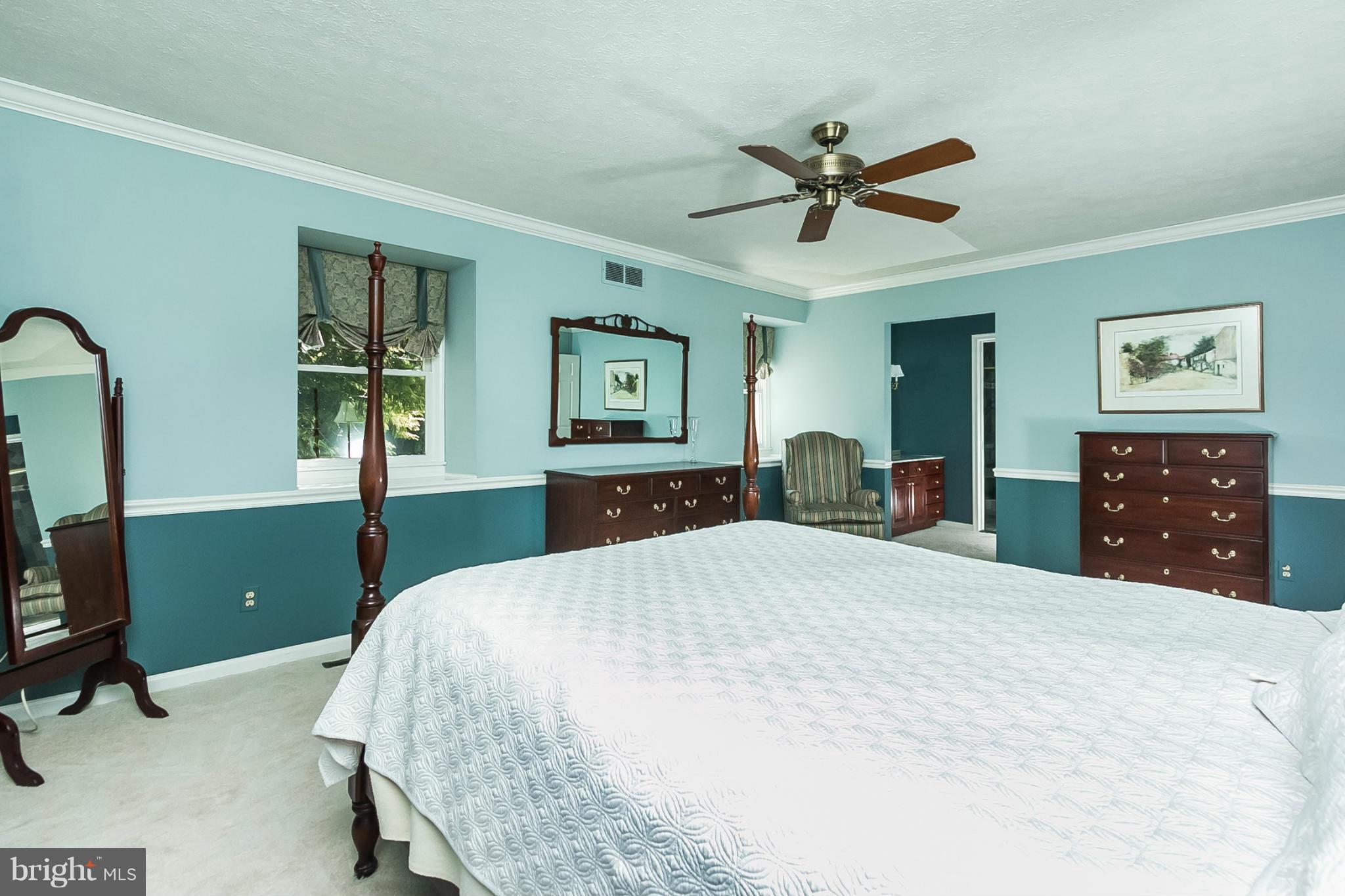14106 Manor Road Phoenix, MD 21131 - Photo 15 of 30 a bedroom with a bed and a chandelier