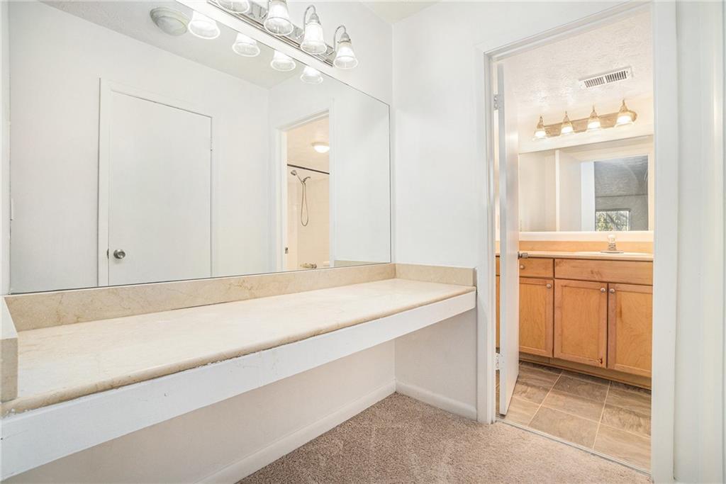 1150 Collier Road Northwest, Unit 12F Atlanta, GA 30318 - Photo 18 of 26 a bathroom with a sink a vanity and a bathtub