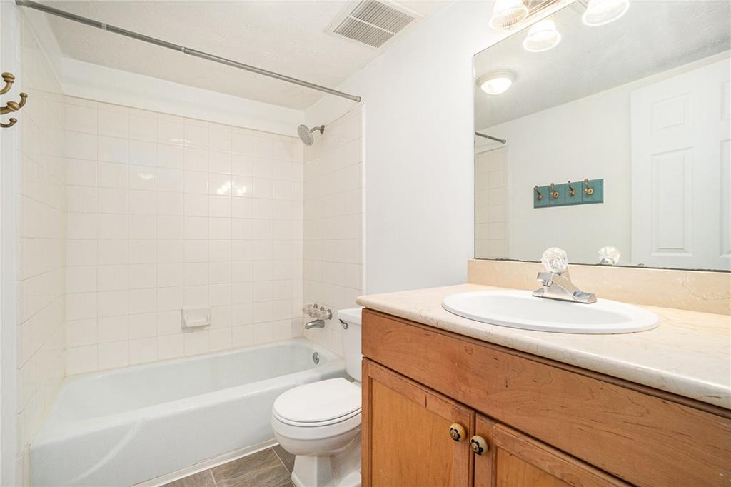 1150 Collier Road Northwest, Unit 12F Atlanta, GA 30318 - Photo 24 of 26 a bathroom with a sink a toilet and a bathtub