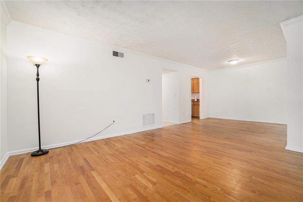 1150 Collier Road Northwest, Unit 12F Atlanta, GA 30318 - Photo 8 of 26 a view of empty room with wooden floor