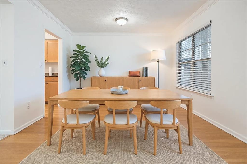 1150 Collier Road Northwest, Unit 12F Atlanta, GA 30318 - Photo 9 of 26 a dining room with furniture and window