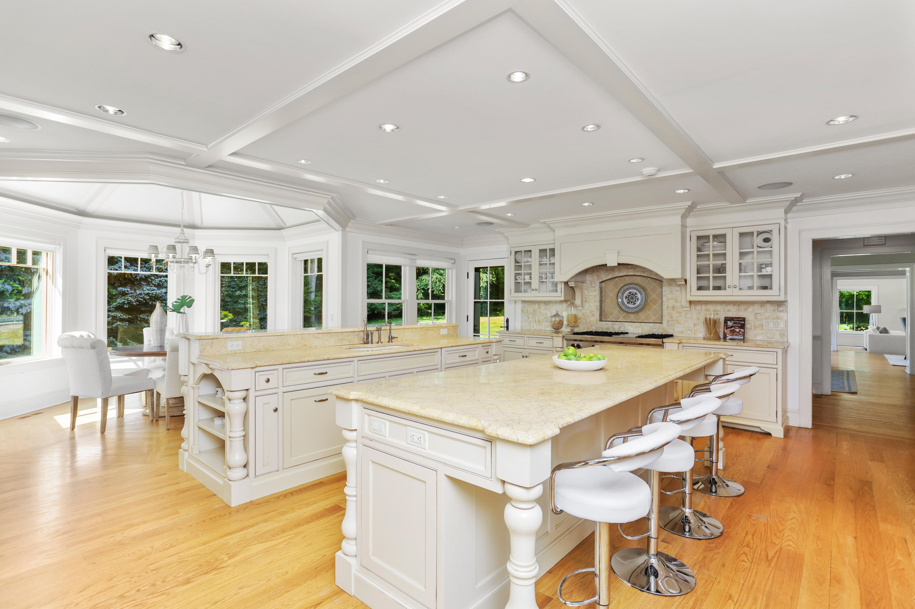 298 Brookside Road Darien, CT 06820 - Photo 3 of 36 a large kitchen with kitchen island a stove a table and chairs in it