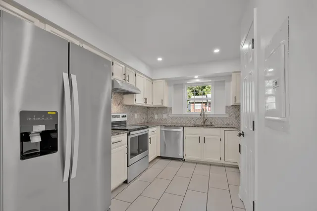 a kitchen with a sink stove and cabinets