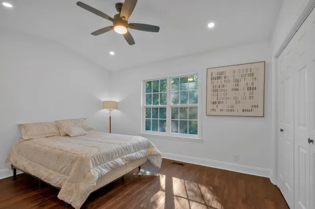 a bedroom with a bed and wooden floor