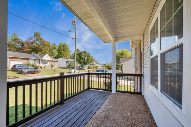 a view of a balcony with wooden floor