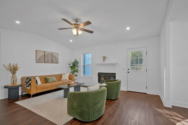 a living room with furniture and a wooden floor