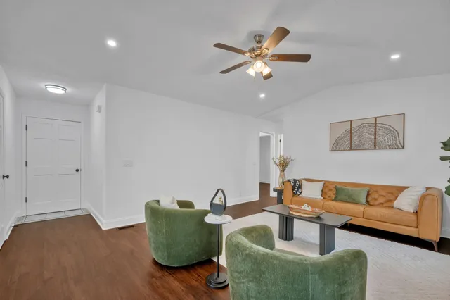 a living room with furniture a fireplace and potted plants