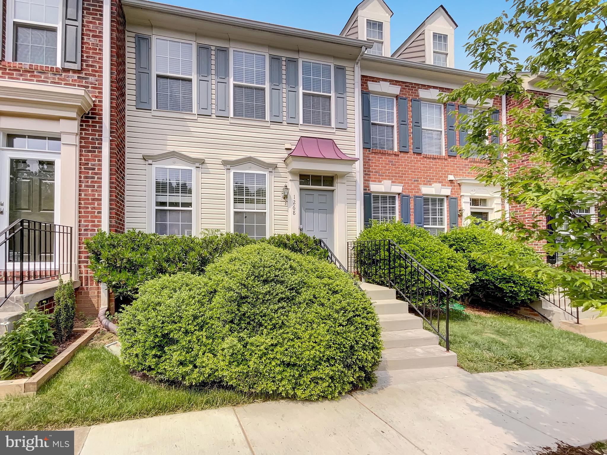 a front view of a residential apartment building with a yard