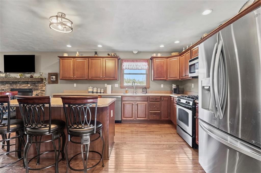 172 Valley Fields Drive Pittsburgh, PA 15239 - Photo 15 of 41 a kitchen with stainless steel appliances granite countertop a stove top oven a refrigerator a sink and a microwave