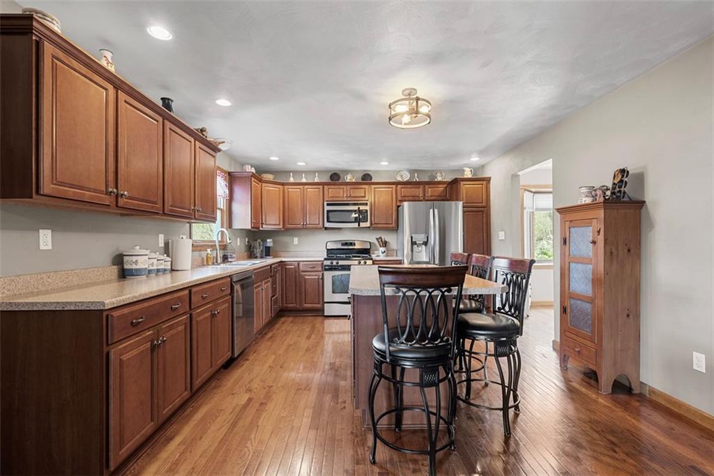 172 Valley Fields Drive Pittsburgh, PA 15239 - Photo 16 of 41 a kitchen with a table chairs microwave and cabinets