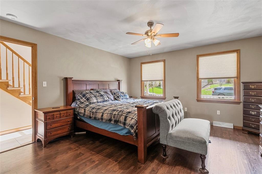 172 Valley Fields Drive Pittsburgh, PA 15239 - Photo 4 of 41 a bedroom with a bed two lamps and a large window