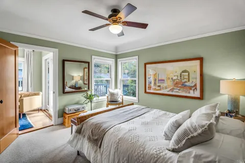 a bedroom with a bed and a large window