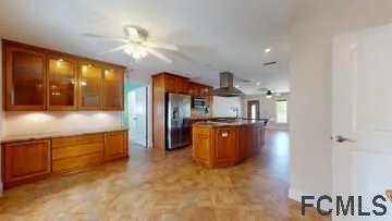 a kitchen with stainless steel appliances granite countertop a refrigerator and a sink