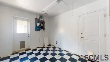 a room with a black white checkered floor with a black white checkered floor