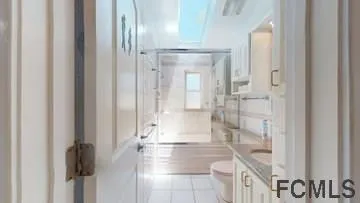 a bathroom with a glass shower door