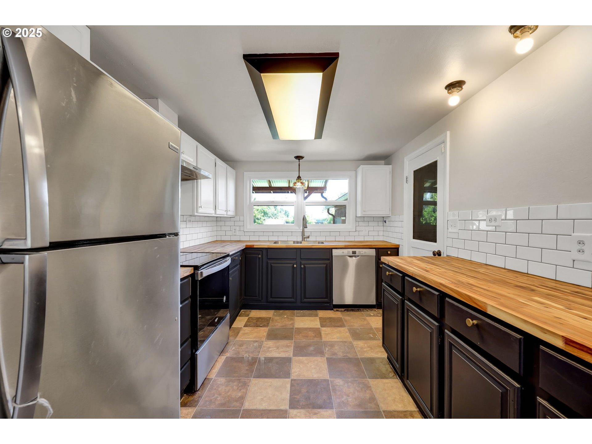 1119 7th Street Springfield, OR 97477 - Photo 14 of 43 a kitchen with stainless steel appliances granite countertop a refrigerator a sink dishwasher a stove with wooden floor