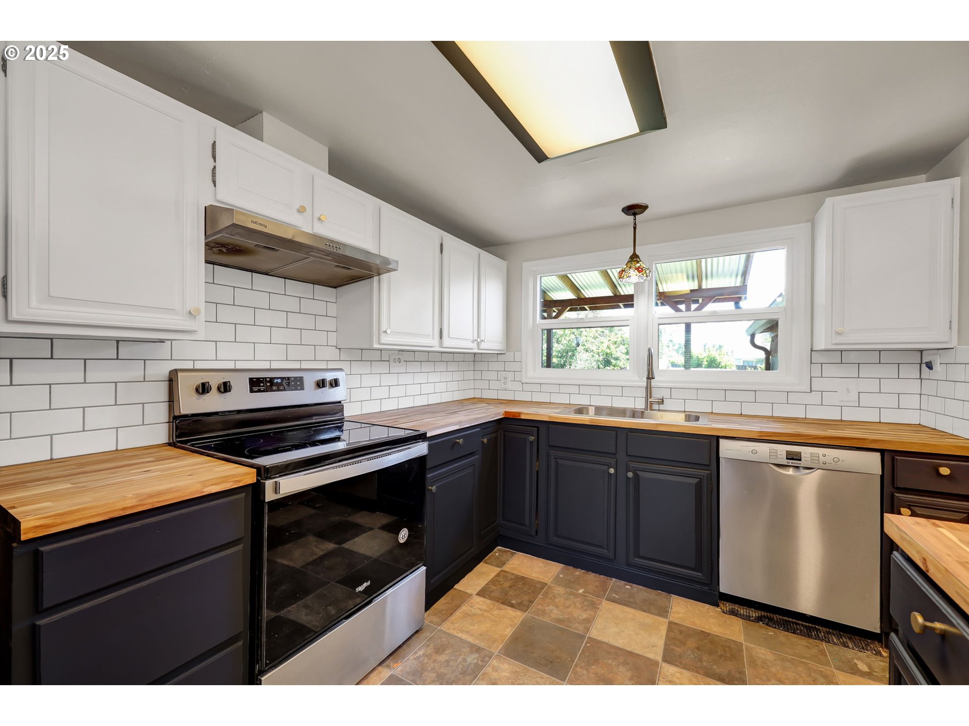 1119 7th Street Springfield, OR 97477 - Photo 15 of 43 a kitchen with stainless steel appliances granite countertop a sink stove and cabinets