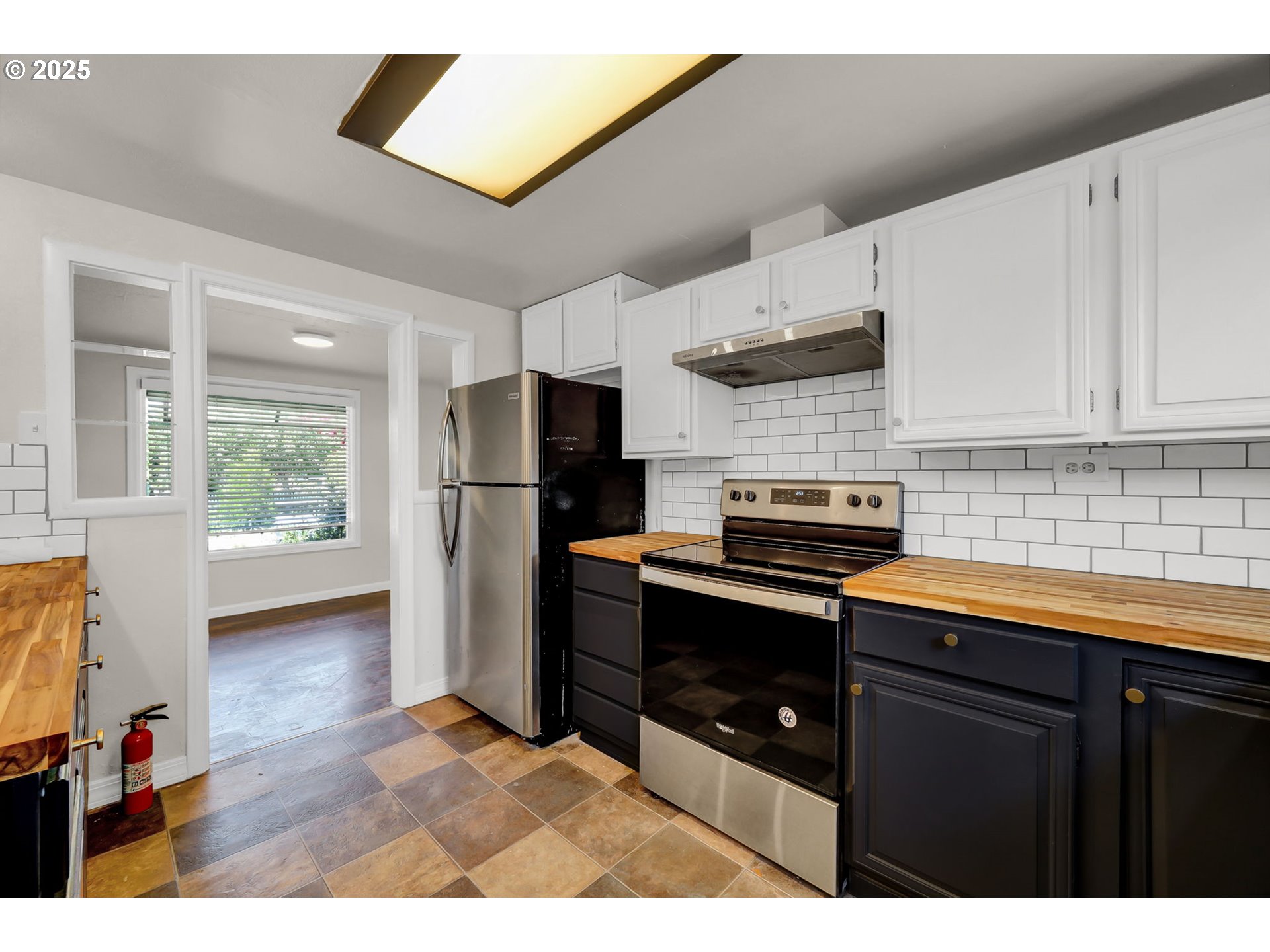 1119 7th Street Springfield, OR 97477 - Photo 17 of 43 a kitchen with stainless steel appliances granite countertop a refrigerator a sink dishwasher a stove and white countertops with wooden floor
