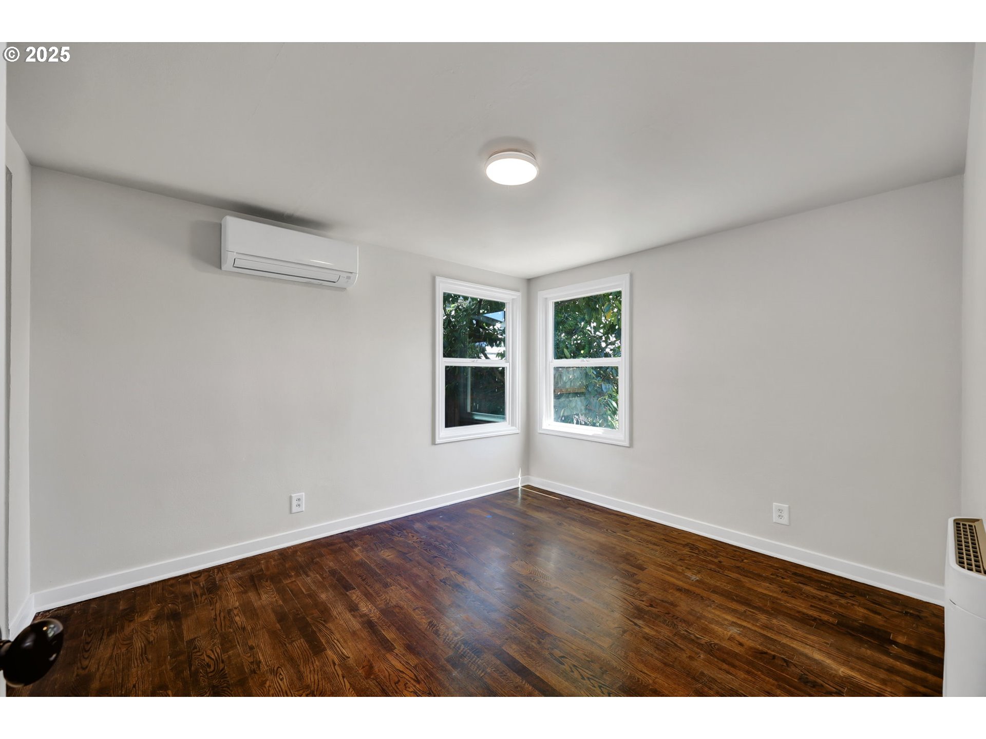 1119 7th Street Springfield, OR 97477 - Photo 21 of 43 a view of an empty room with wooden floor and a window
