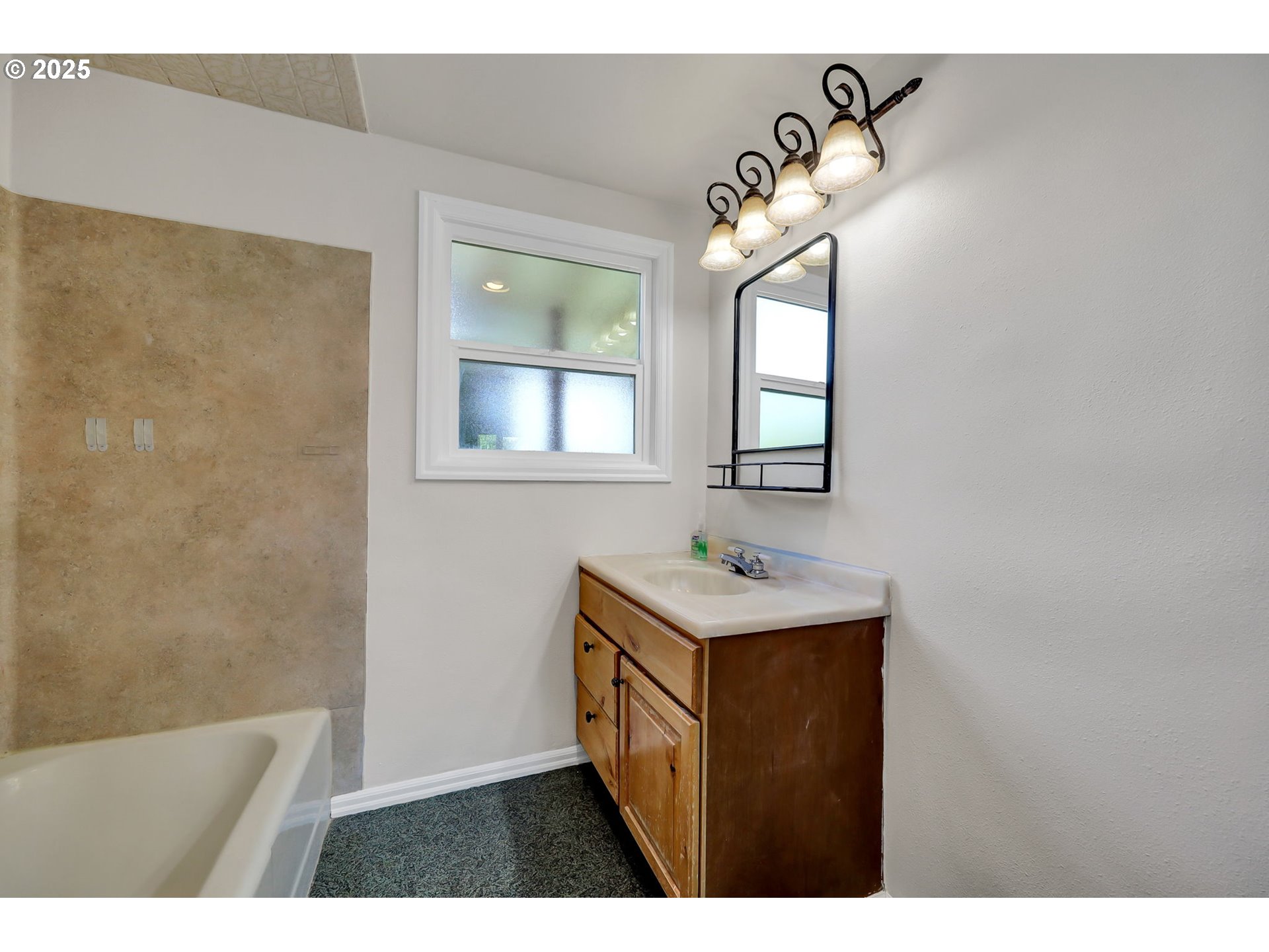 1119 7th Street Springfield, OR 97477 - Photo 24 of 43 a bathroom with a sink a light fixture and a mirror