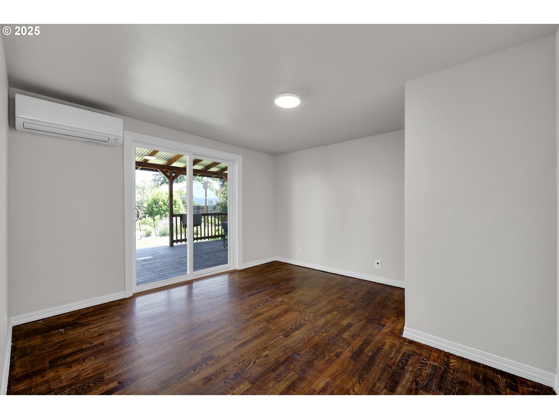 1119 7th Street Springfield, OR 97477 - Photo 25 of 43 a view of an empty room with wooden floor and a window