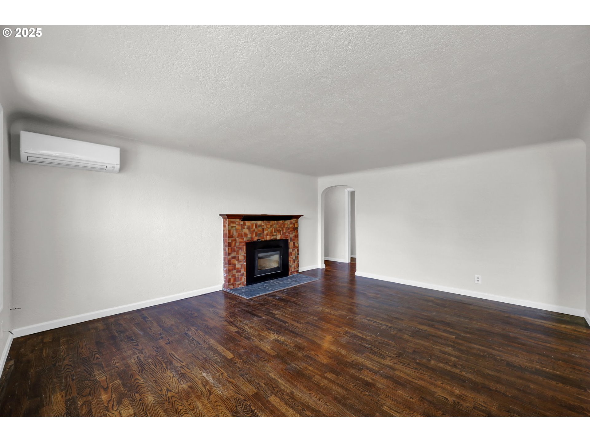 1119 7th Street Springfield, OR 97477 - Photo 5 of 43 a view of an empty room with wooden floor and a fireplace