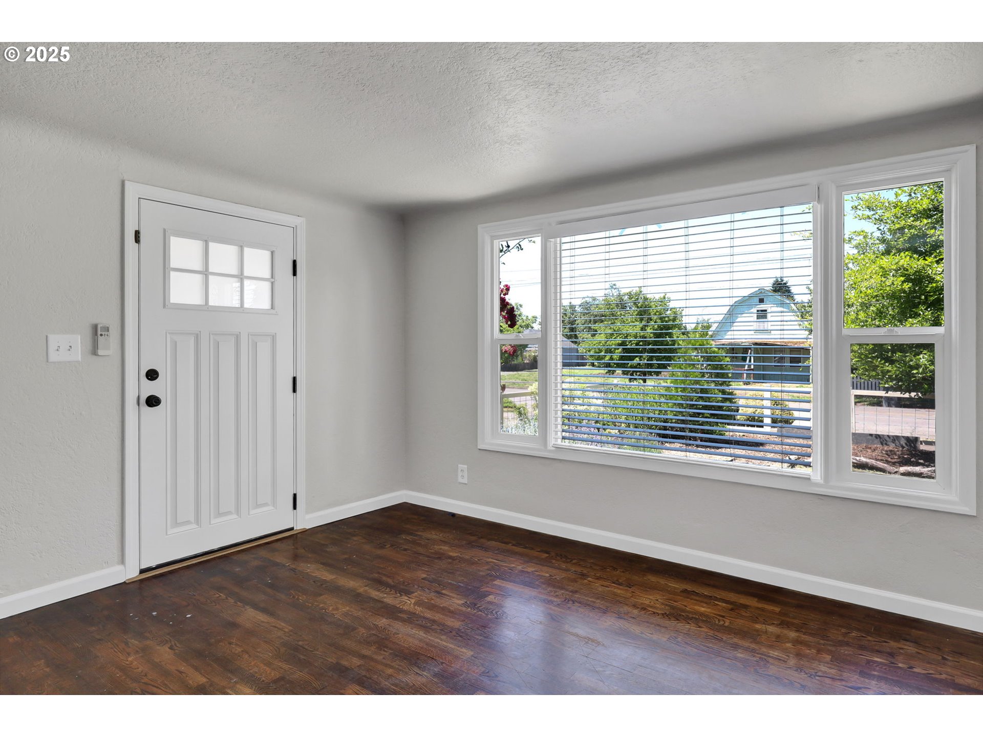 1119 7th Street Springfield, OR 97477 - Photo 6 of 43 a view of an empty room with wooden floor and a window