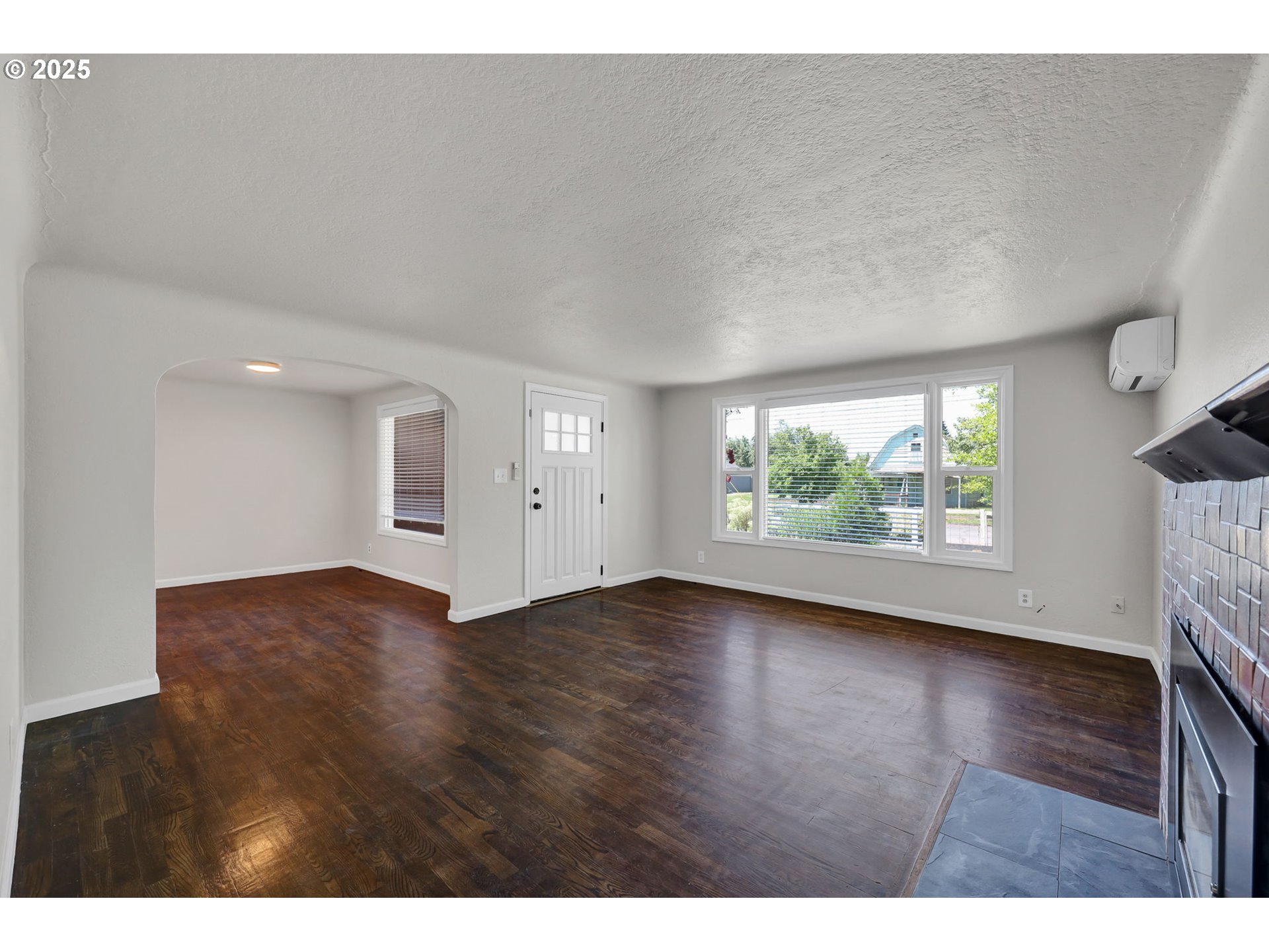 1119 7th Street Springfield, OR 97477 - Photo 8 of 43 a view of an empty room with a window and wooden floor
