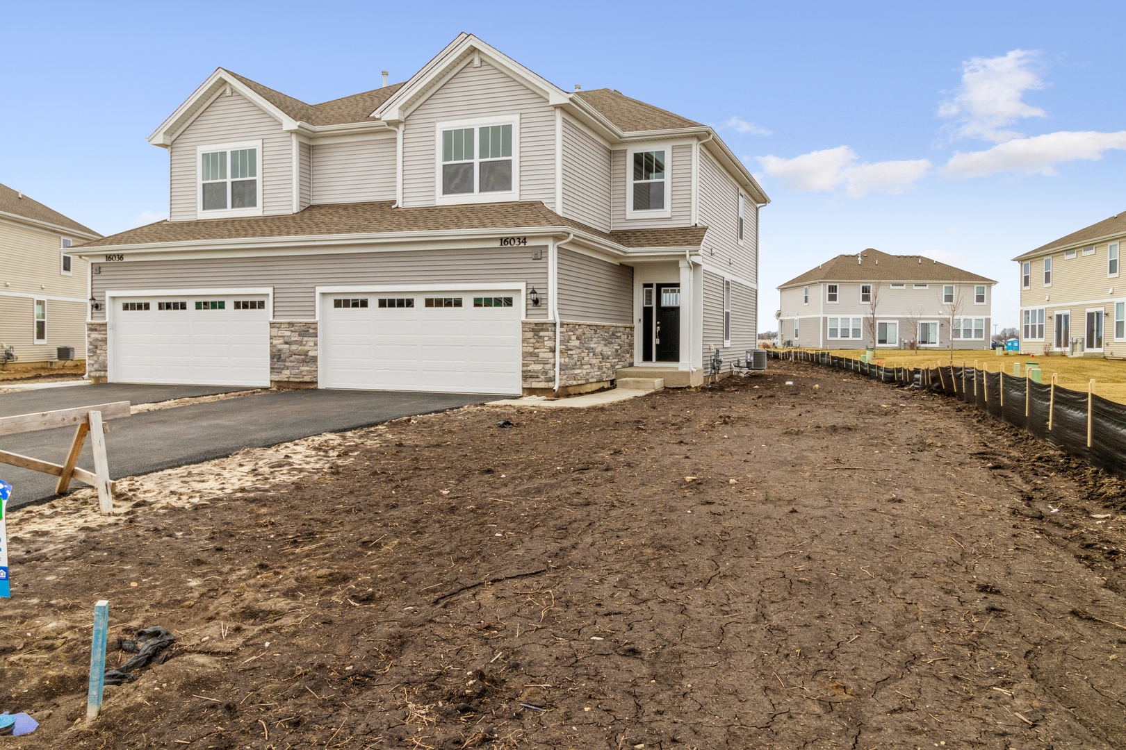 a view of a white house with a yard