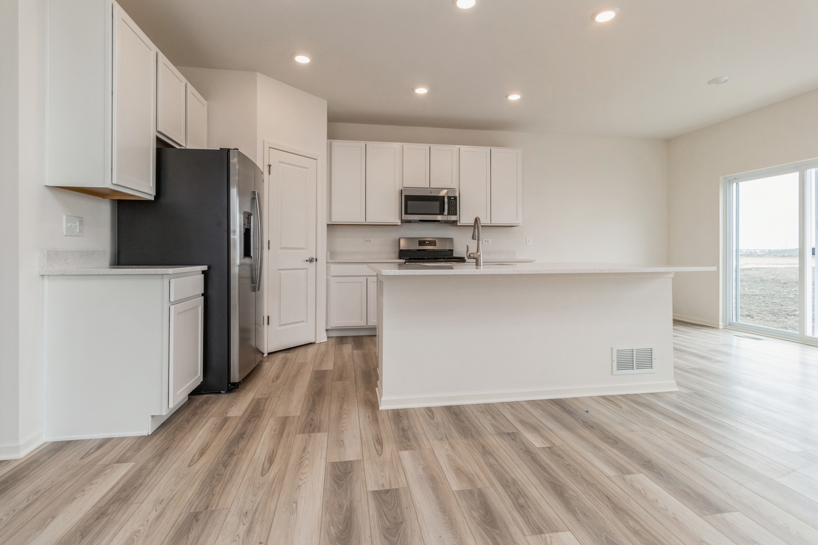 25624 West Springview Drive Plainfield, IL 60586 - Photo 2 of 22 a kitchen with stainless steel appliances a refrigerator and a stove top oven