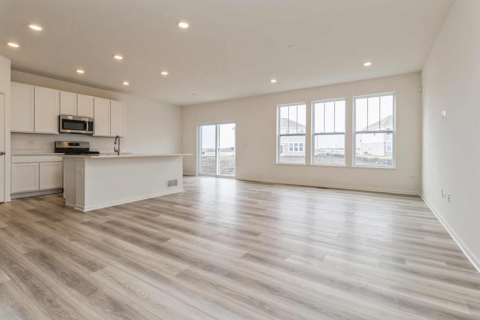 25624 West Springview Drive Plainfield, IL 60586 - Photo 4 of 22 a view of a kitchen with a sink and dishwasher a oven with wooden floor