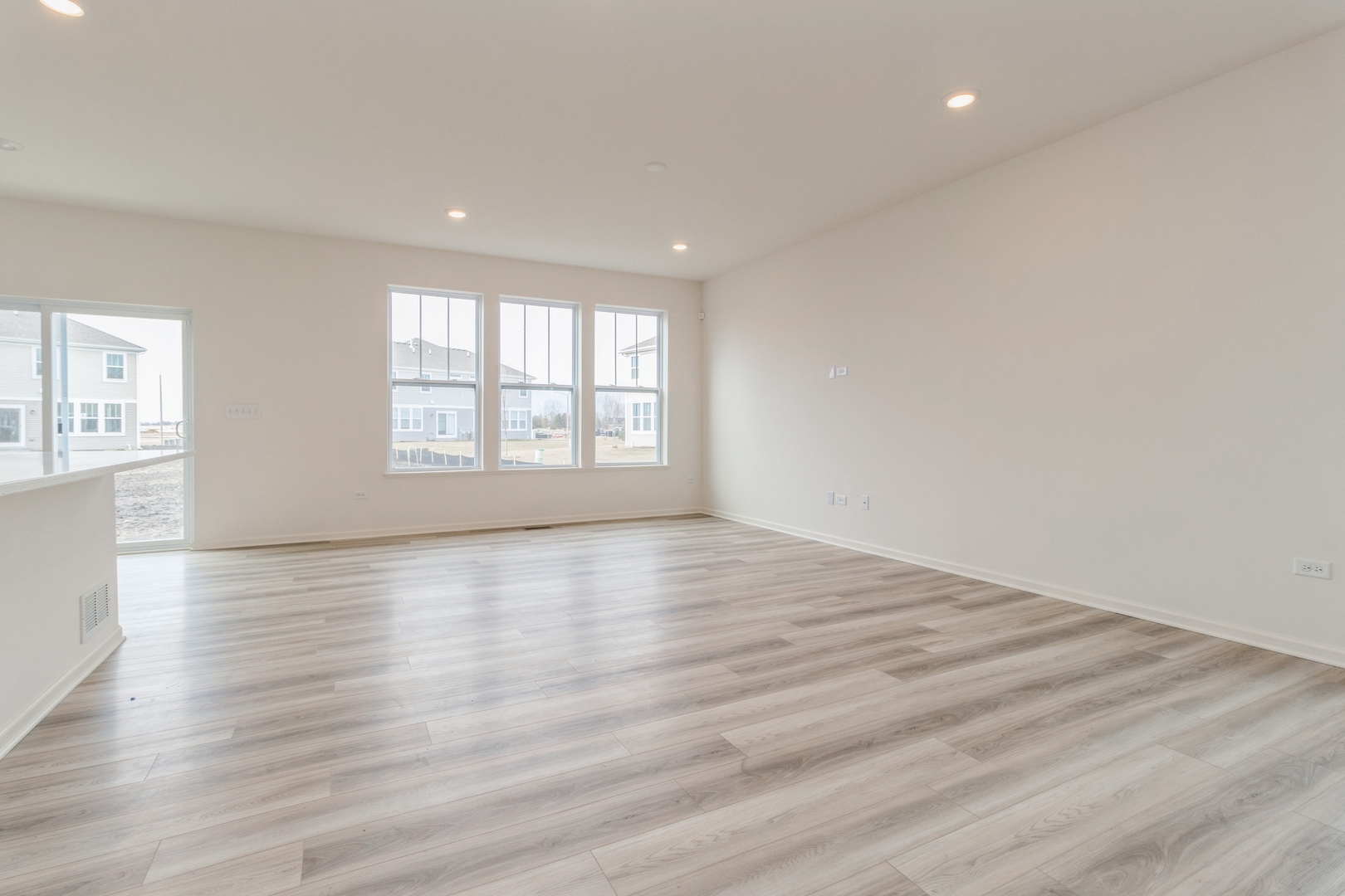 25624 West Springview Drive Plainfield, IL 60586 - Photo 5 of 22 an empty room with wooden floor and windows