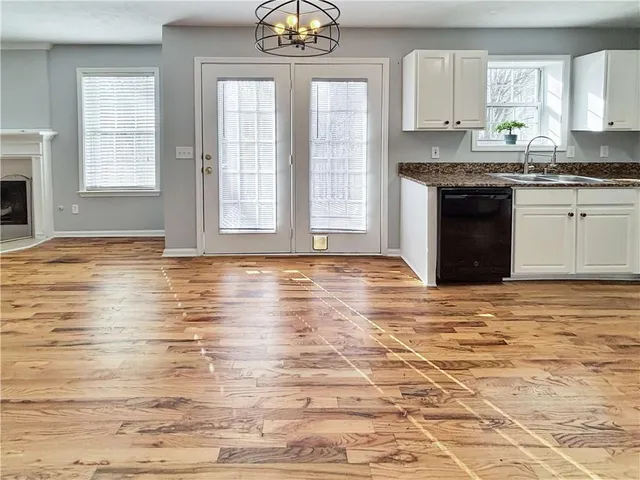 a view of a kitchen with granite countertop cabinets and a fireplace
