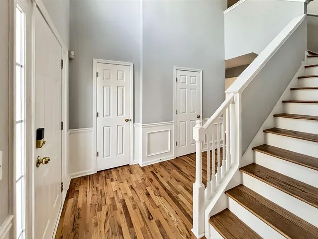 a view of a hallway with wooden floor and entryway