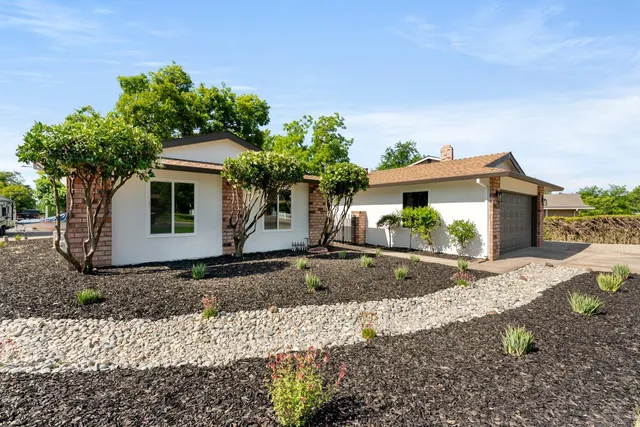 a front view of a house with garden