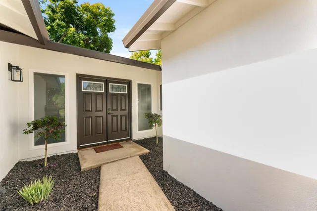 a view of a hallway with wooden floor and closet area