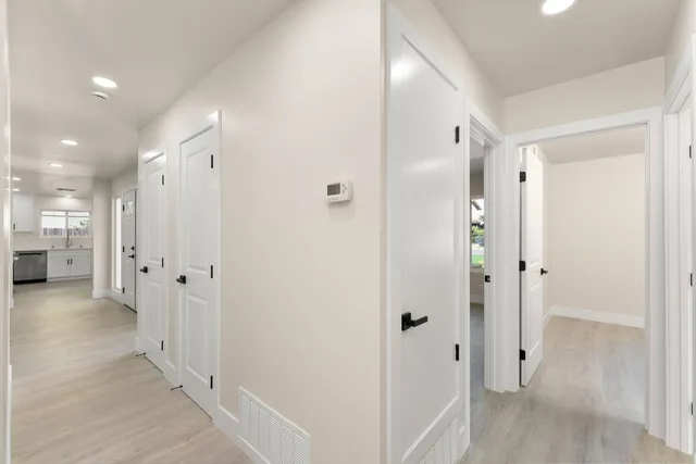 a kitchen with white cabinets and white appliances
